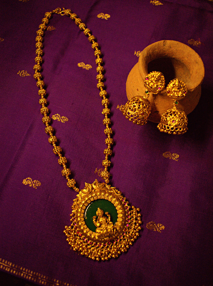 Gold Lakshmi Medallion Necklace with Green Stone and Matching Jhumka Earrings