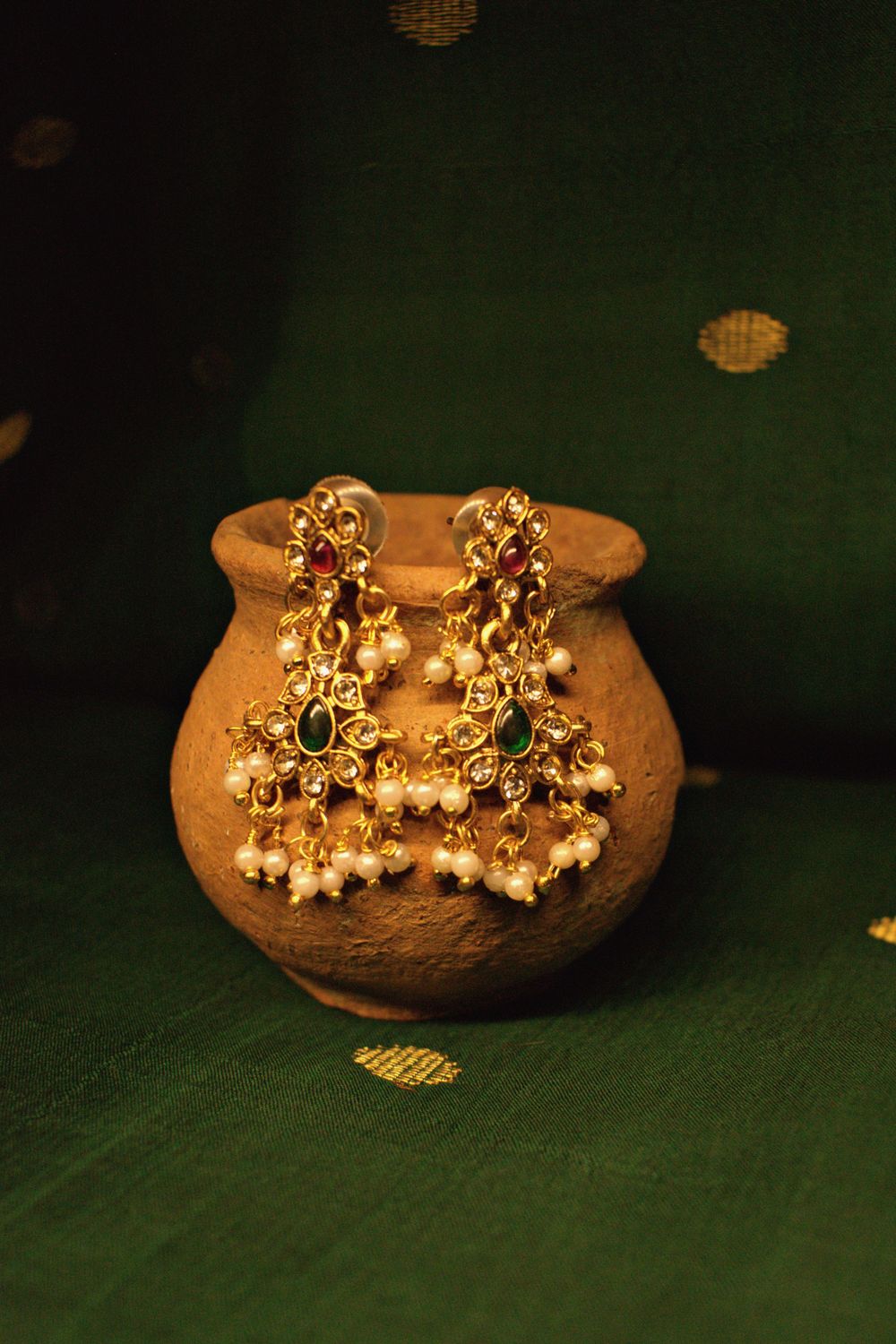 Antique gold temple jewellery on green silk