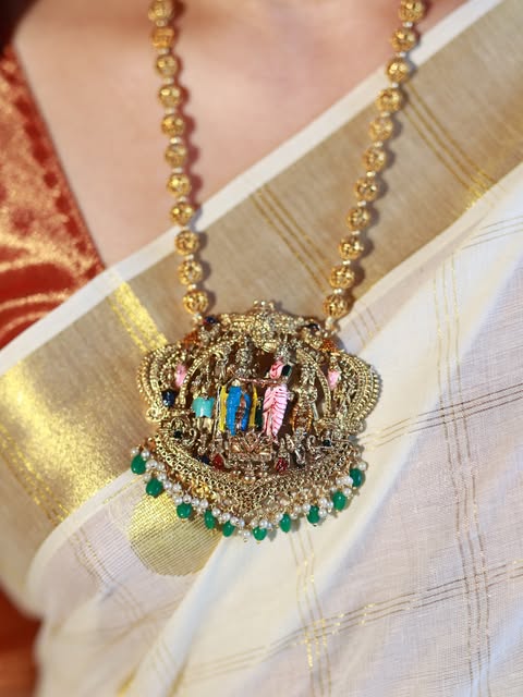 Antique gold temple pendant worn with a kasavu drape